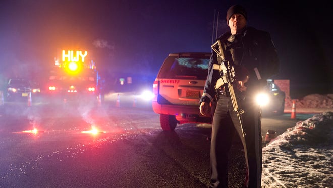Sgt. Tom Hutchison stands in front of an Oregon State Police roadblock on Highway 395 on Tuesday, Jan. 26, 2016 between John Day and Burns, Ore.