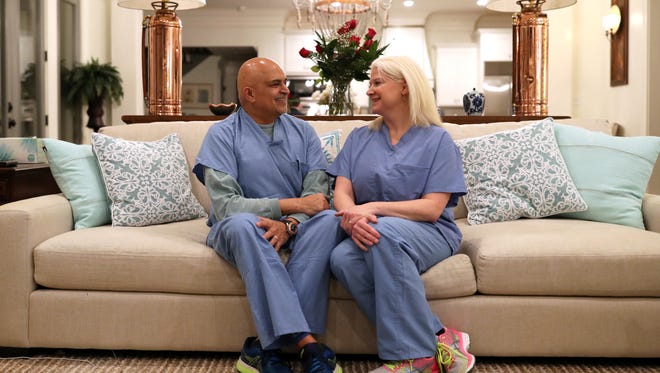 Cardiologists Carey Dellock and Niraj Pandit, still in their scrubs from a day’s work at Capital Regional Medical Center, also share matters of the heart off the clock as a married couple, shown at their Tallahassee home on Tuesday, Feb. 13, 2018.