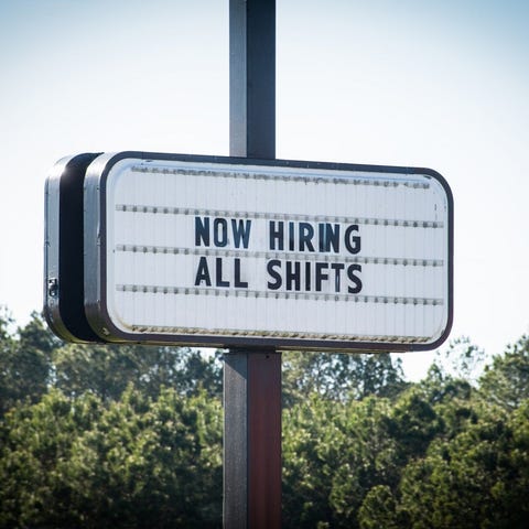 Sign that reads now hiring all shifts.