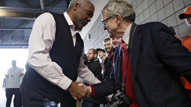 Ohio State athletic director Gene Smith greets Ohio Gov. Mike DeWine as the team enters the stadium before the College Football Playoff semifinal in Glendale, Ariz., on   Dec. 28, 2019.