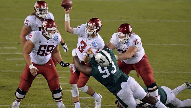 Washington State quarterback Tyler Hilinski (3) is pressured by Michigan State defensive tackle Naquan Jones (93) as he throws during the fourth quarter of Thursday's Holiday Bowl.