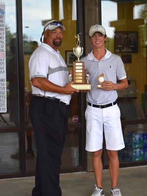 West Florida High's Colby Goodwin, joined by Osceola Golf pro and general manager Adrian Stills, whose name is on the trophy, after winning the City of Pensacola boys junior title earlier this week.