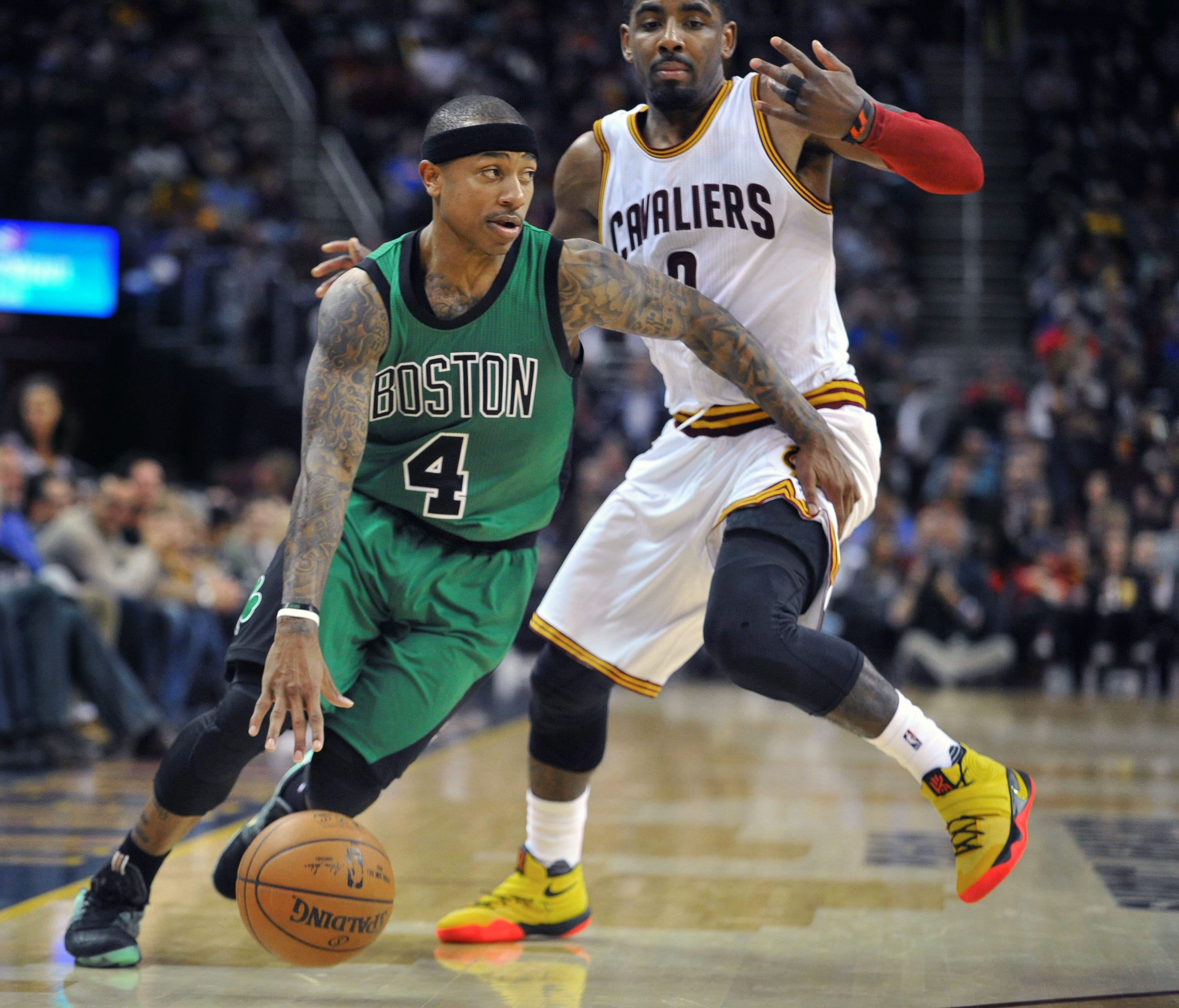 Former Boston Celtics guard Isaiah Thomas dribbles past former Cleveland Cavaliers guard Kyrie Irving.