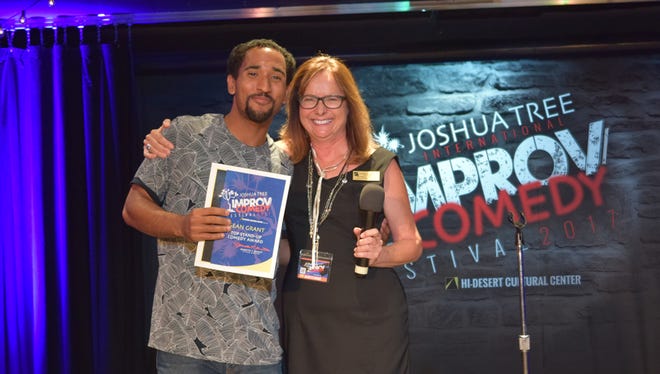 Sean Grant, winner of the grand prize “sweepstakes” award of the Joshua Tree International Improv Comedy Festival, poses with festival founder and producer Jeanette Knight.