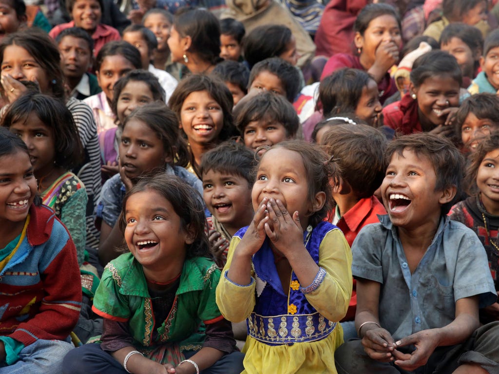 Impoverished Indian children watch a performance as part of advocacy against child labor in Allahabad, India. Despite the country's rapid economic growth, child labor remains widespread in India, where an estimated 13 million children work, with laws