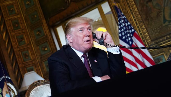 US President Donald Trump speaks to members of the military via teleconference from his Mar-a-Lago resort in Palm Beach, Florida, on Thanksgiving Day, November 22, 2018.