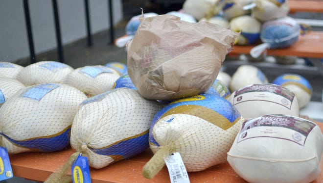 Turkeys donated during a turkey drive at Bluebird BBQ in Burlington wait on picnic tables outside the restaurant before being brought to the Chittenden Emergency Food Shelf on Sunday, Nov. 19, 2017.