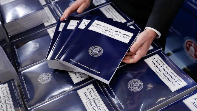 In this May 23, 2017, file photo, copies of President Trump's fiscal 2018 federal budget are seen on Capitol Hill.