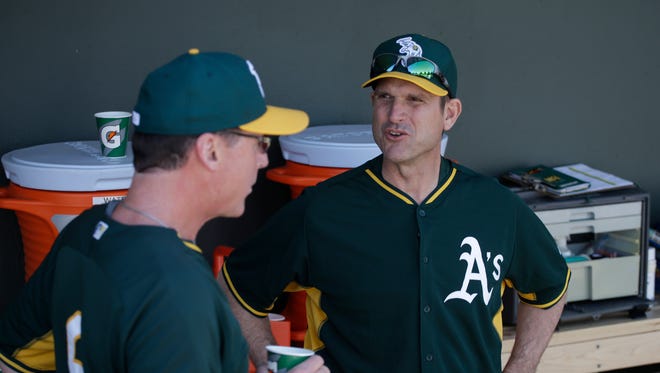 March 7, 2015: Jim Harbaugh joins Oakland Athletics spring training in Arizona for a day. Manager Bob Melvin (left) is a good friend of Harbaugh's.