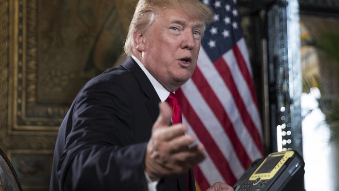 In a Sunday, Dec. 24, 2017 file photo, Donald Trump talks during a teleconference at his Mar-a-Lago estate in Palm Beach, Fla. President Donald Trump is criticizing the U.S. Postal Service, saying the agency is “losing many billions of dollars a year” and asking why it is “charging Amazon and others so little to deliver their packages.” Trump tweeted Friday, Dec. 29, that the post office “should be charging MUCH MORE!”