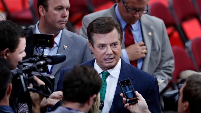 In this July 17, 2016, file photo, Paul Manafort is surrounded by reporters on the floor of the Republican National Convention in Cleveland.