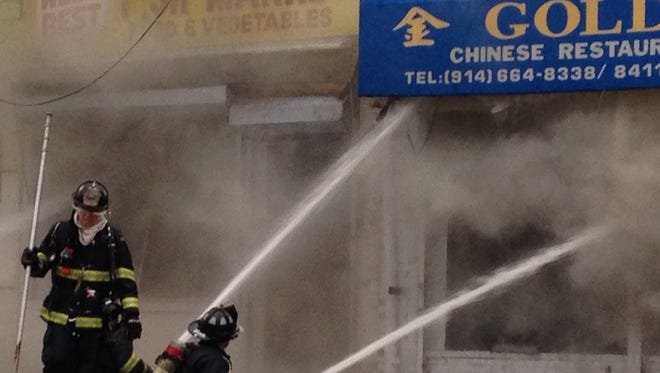 Firefighters battle the blaze Sunday morning at Golden Gate Chinese Restaurant at 27-29 W. Sandford Blvd., Mount Vernon.