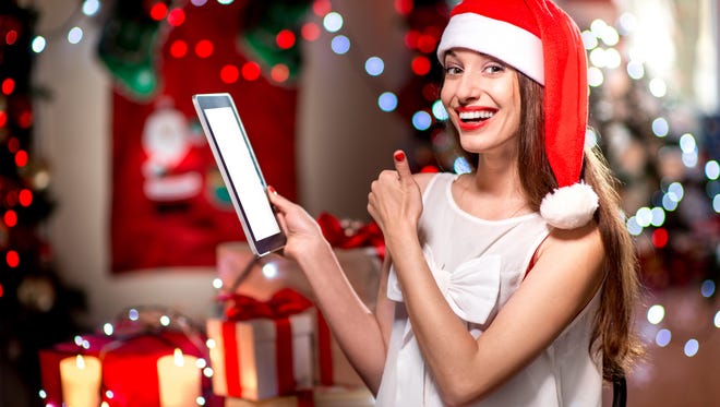 Young woman using tablet at Christmas decorated home