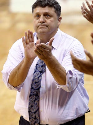 Oakland coach Greg Kampe applauds his team after a basket against Pittsburgh during the second half of an NCAA college basketball game, Saturday, Dec. 20, 2014, in Pittsburgh. Pittsburgh won 81-77 in overtime.