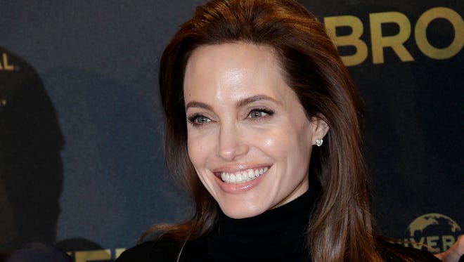 Director Angelina Jolie poses for photographers during a photo call for her film "Unbroken" in Berlin, Germany on Nov. 27, 2014.