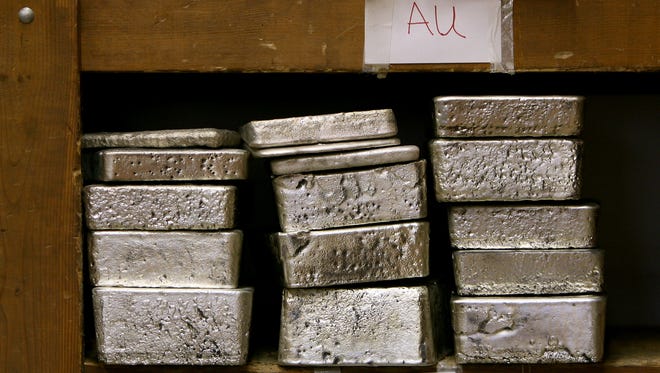 Melted down lots of gold (top) and silver sit inside a vault at SilverTowne in Winchester in this file photo.