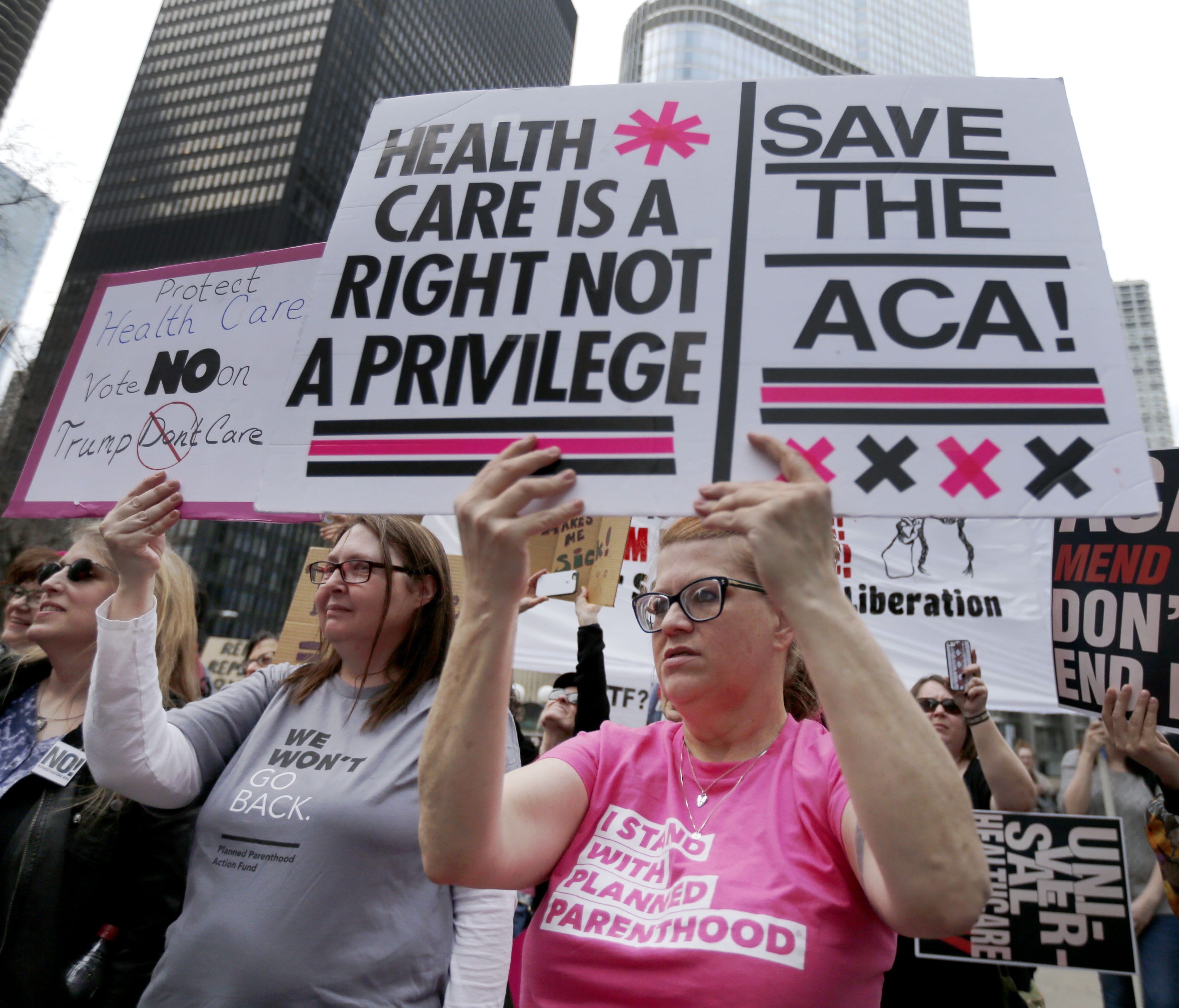 Protesters gather across the Chicago River from Trump Tower to rally against the repeal of the Affordable Care Act.