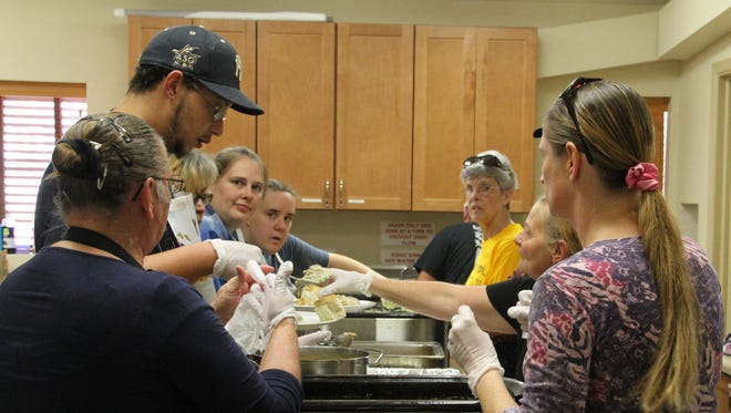 Our Savior Lutheran Church volunteers prepare meals during their Thanksgiving Day meal.