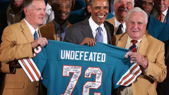 Evansville native Bob Griese (left) poses for photos with then-President Barack Obama as he hosted the 1972 Super Bowl champion Miami Dolphins on Aug. 20, 2013 at the White House. Former Dolphins coach Don Shula is on the right.
