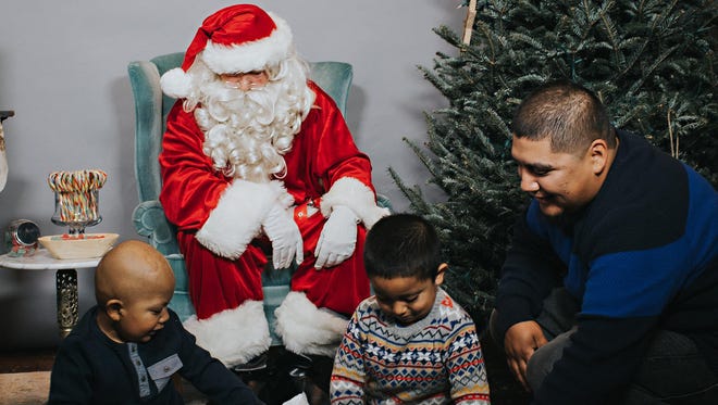 At Hang Tough Foundation's Santa Day, families like the Franciscos, whose son Michael is diagnosed with Brain Cancer, receive a toy for each of their children off their wish list from Santa.