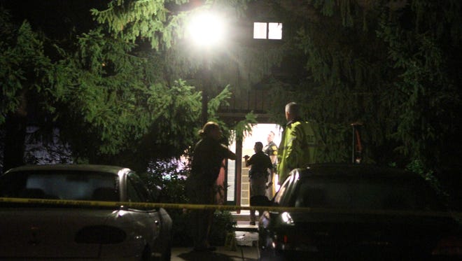 Authorities on Sept. 22, 2013, investigate the Fox Point condo building of Joseph and Olga Connell, who were killed outside the building.