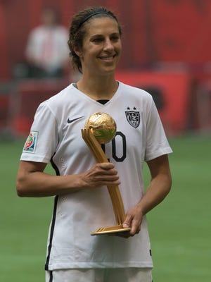 United States' Carli Lloyd holds her Golden Ball award which was presented after the United States defeated Japan to win the FIFA Women's World Cup soccer championship in Vancouver, British Columbia, Canada, Sunday, July 5, 2015. (Jonathan Hayward/The Canadian Press via AP)
