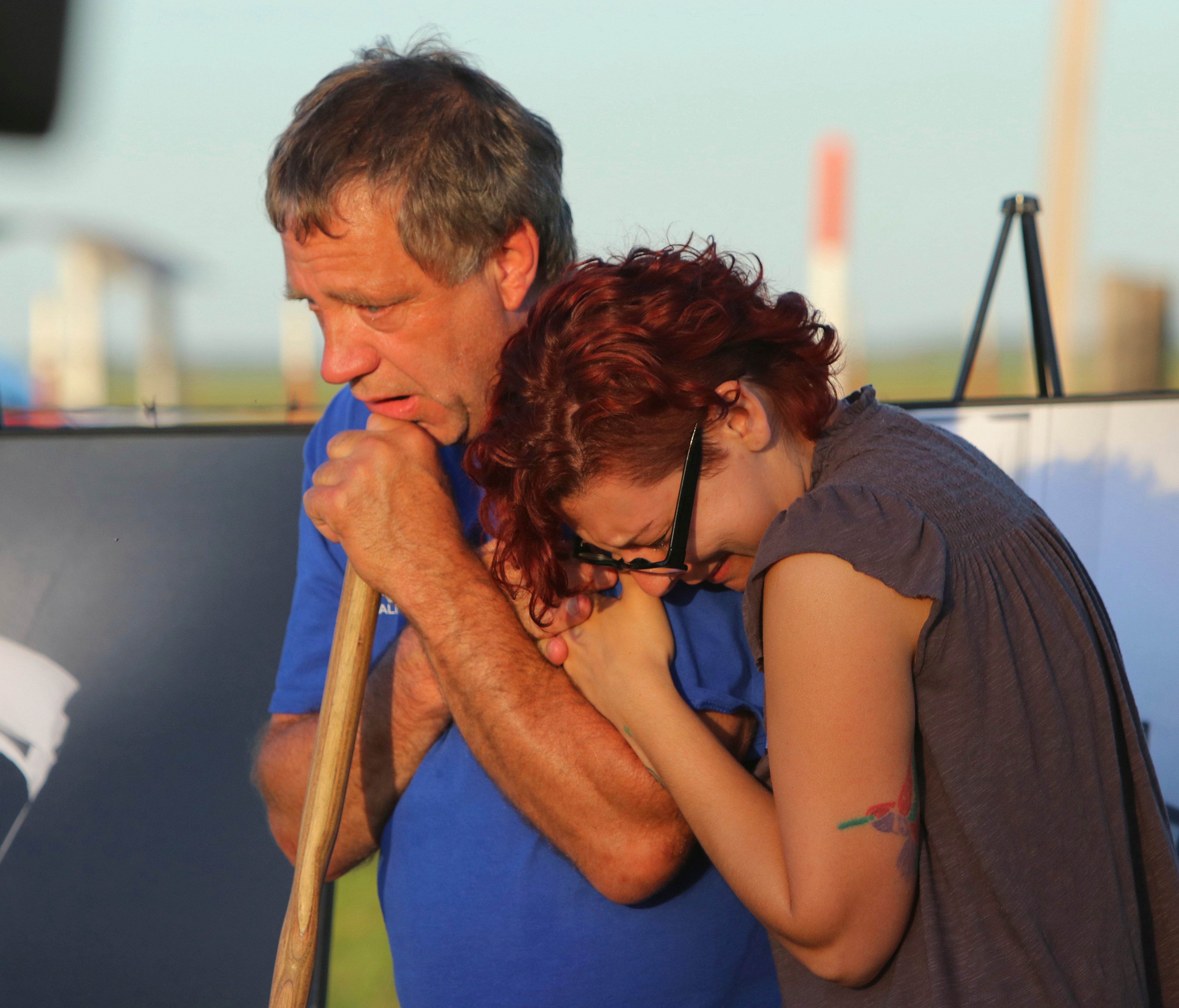 In this April 24, 2017 photo, anti-death penalty supporter Randy Gardner, left, embraces Gina Grimm, daughter of inmate Jack Jones, outside the Varner Unit near Varner, Ark. Jack Jones and Marcel Williams received lethal injections on the same gurney