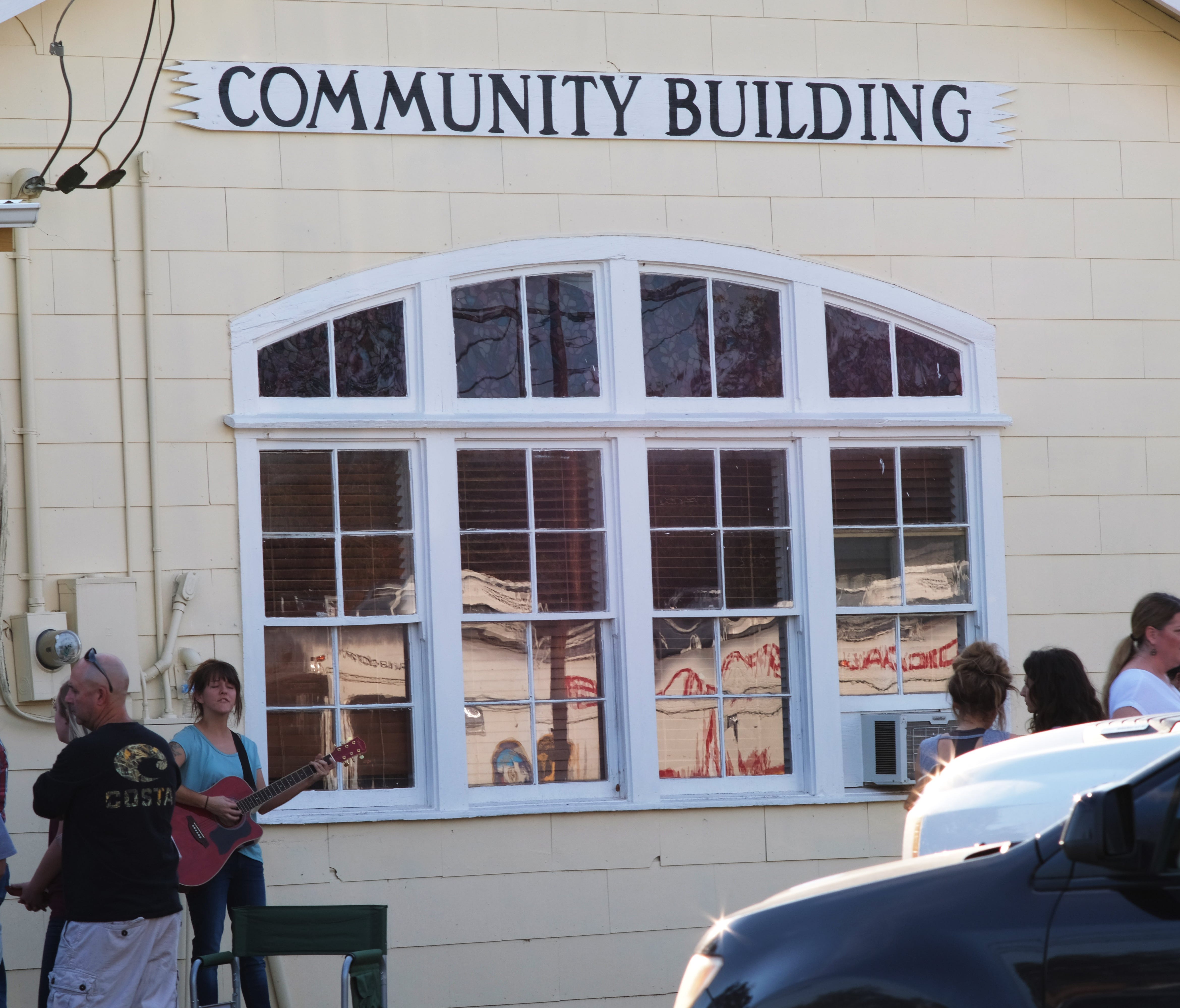 People gather outside the Sutherland Springs Community Building near the scene of a mass shooting at the First Baptist Church in Sutherland Springs, Texas, on Nov. 5, 2017.