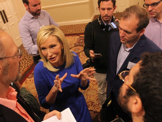 Paula White talks to reporters at the Religion News