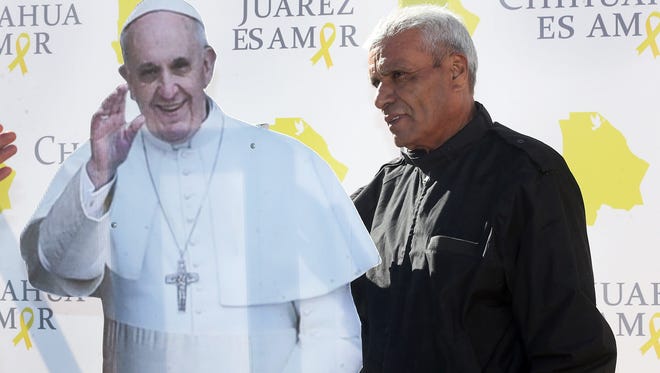 Alfonso Lopez Diaz of Juárez poses for a photo with a cutout of Pope Francis along 16th of September Boulevard in downtown Juárez recently. The pope is scheduled to visit Juárez on Feb. 17.