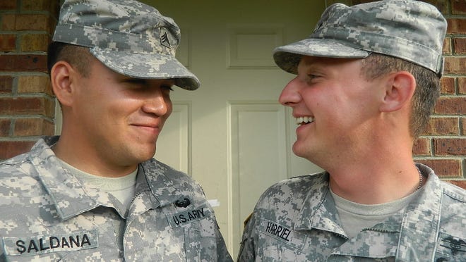 
Married couple Sgt. Cristian Saldana and Spc. Nicholas Harriel in front of their home. 
