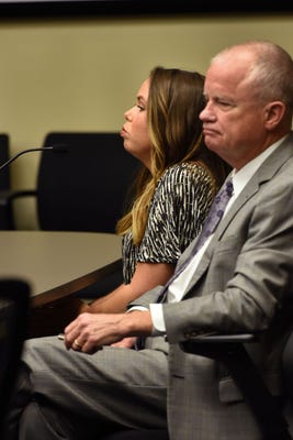 kelsey mccarter and her attorney doug trant sit in