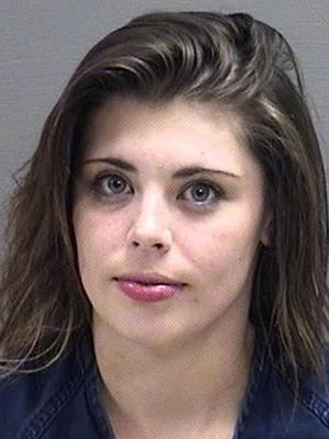 Briana Moore, 22, is accused of breaking into a vacant house for sale with her companion. Both were found naked in a bedroom in Great Falls, Mont.