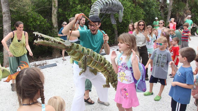 Nick Augustine, of IBEX Puppetry, entertains children with his crocodile puppet during “Ding” Darling Days in celebration of National Wildlife Refuge Week on Sanibel on Sunday.