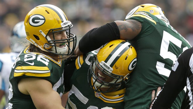 Green Bay Packers outside linebacker Nick Perry celebrates his sack with teammate Clay Matthews, left, and Julius Peppers in the first quarter.

The Green Bay Packers host the Carolina Panthers Sunday, October 19, 2014, at Lambeau Field in Green Bay, Wis. 
Wm. Glasheen/Post-Crescent Media
