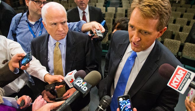Sen. John McCain, left, and Sen. Jeff Flake answer questions at the conclusion of the Conversation On Immigrationon Tuesday, Aug. 27, 2013, at the Mesa Arts Center.
