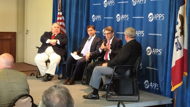 Former Texas Gov. Rick Perry (second from right), speaks at a national security forum in Des Moines Tuesday. Also on stage, from left, were college professor Sam Clovis, Associated Press reporter Ken Dilanian and former Iowa National Guard adjutant general Ron Dardis.