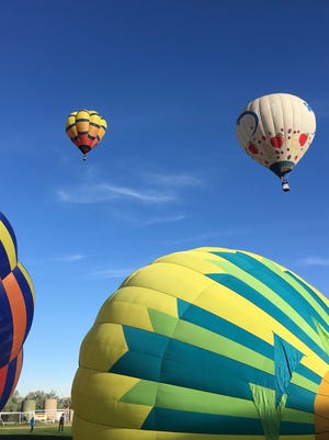 Hot air balloons inflate and take off from the Chamblee Soccer Complex at the Boys & Girls Club of Bloomfield during the San Juan River Balloon Rally June 16 in Bloomfield.
