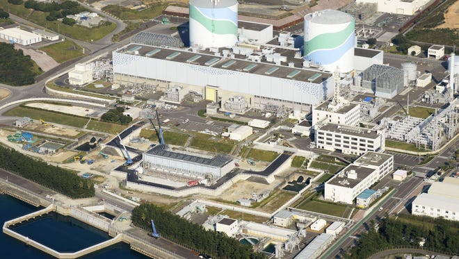 This Oct. 24, 2014 aerial photo shows two reactors at the Sendai Nuclear Power Station in Satsumasendai, Kagoshima Pref., southern Japan. The Kagoshima Prefectural governor has given final approval to restart the nuclear power plant in southern Japan, the first to resume operations in the country under new safety rules imposed in the wake of the 2011 Fukushima Dai-ichi meltdowns caused by a tsunami.