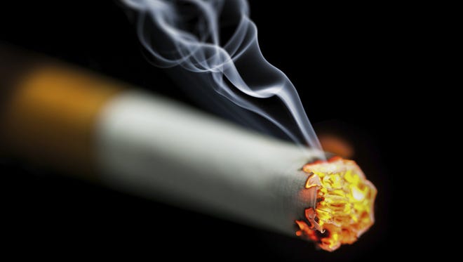 Burning cigarette with smoke