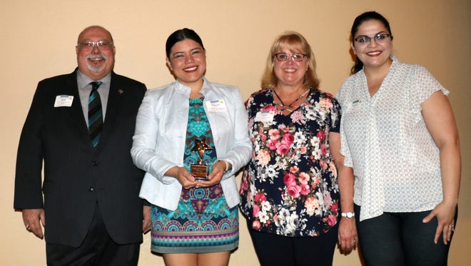 Door County Visitor Bureau Director Jack Moneypenny, left, gives Gabriela Lamas her award. Also pictured are Laura Kevin and Yvonne Torres.