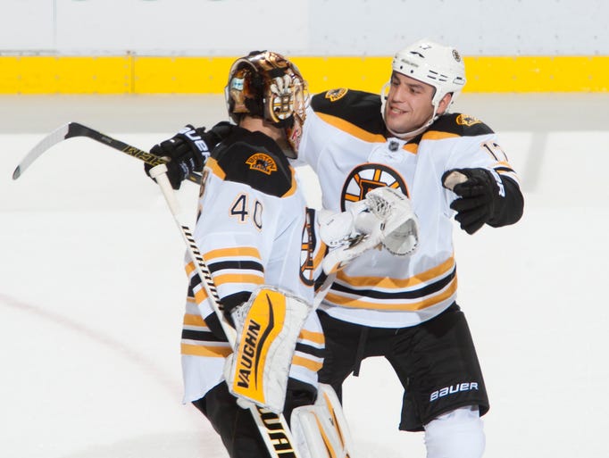 Boston left wing Milan Lucic congratulates goalie Tuukka