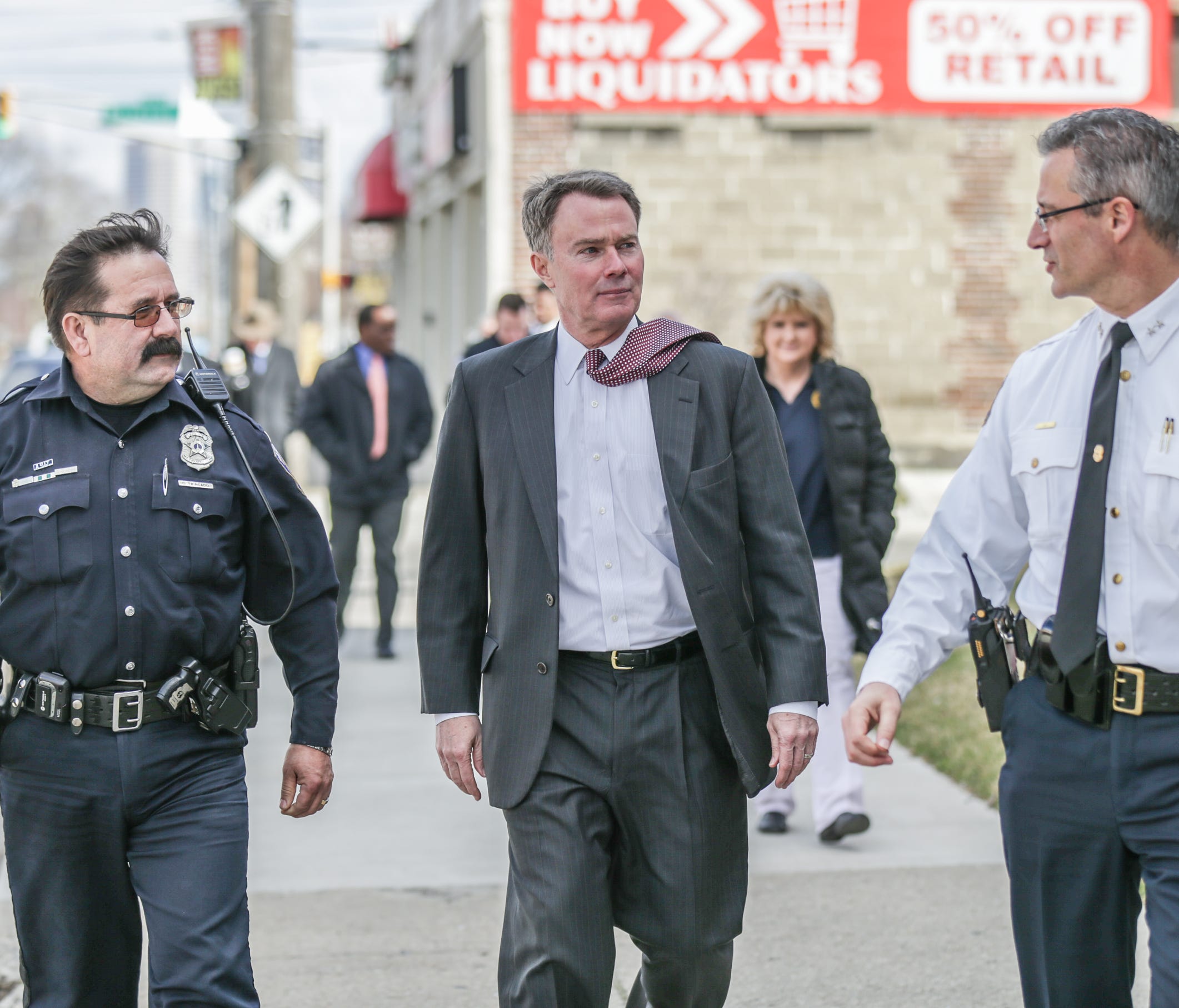 Left to right, IMPD Officer Carlos Trincado, Indianapolis Mayor Joe Hogsett, and IMPD Police Chief  Bryan Roach, walk the neighborhood around west Washington St. talking with residents about deportation fears, and how IMPD will approach immigration s
