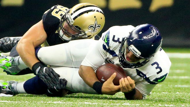 Oct 30, 2016; New Orleans, LA, USA; New Orleans Saints defensive end Paul Kruger (99) sacks Seattle Seahawks quarterback Russell Wilson (3) during the first quarter of a game at the Mercedes-Benz Superdome. Mandatory Credit: Derick E. Hingle-USA TODAY Sports