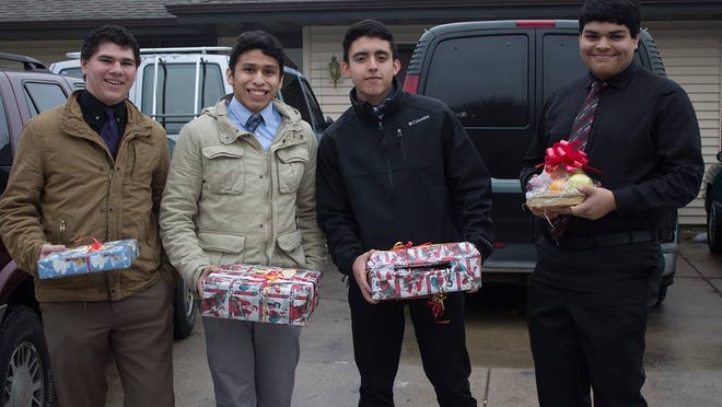 From right: David Avalos, Joe Donohue, Christian Osornio and Cristian Estrada, students at St. Lawrence Seminary High School, prepare to deliver Christmas gifts to children of incarcerated parents.