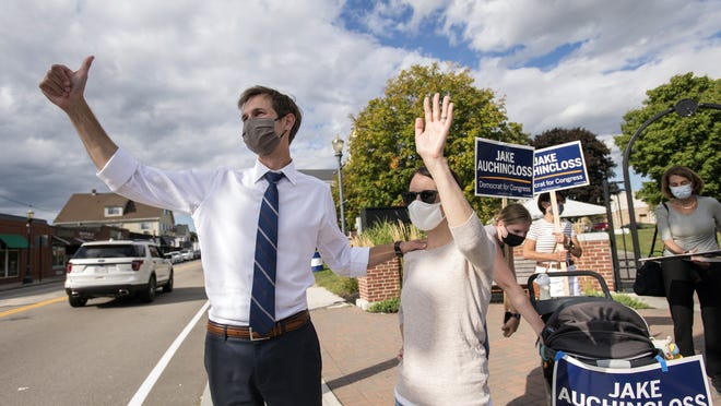 Jake Auchincloss, a Democratic candidate for the 4th Congressional District seat, and his wife, Michelle Gattineri, wave to supporters in Needham, Sept. 1, 2020.
