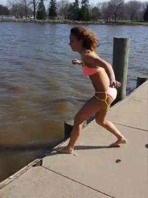 Kayla Jacob, 16, of Lamartine, prepares to jump into Lake Winnebago in Fond du Lac in this screenshot shot by her brother for her cold water challenge. Jacob landed on shells damaging her knee.