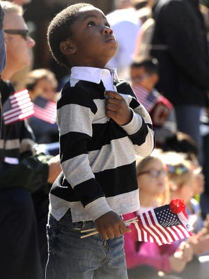 Kenyon Rashaw, 4, puts his hand over his heart during the 2015 Veterans Day parade in Abilene.