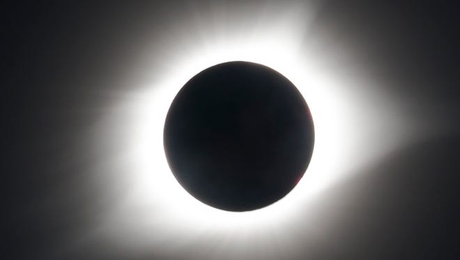 The corona of the sun glows brightly beyond the edge of the moon during the Great American Eclipse on Aug. 21.