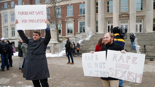 Robert Von Wolheim, left, and Colten Austerman take part in a rally against sexual assault Monday, February 15, 2016, in front of Hovde Hall on the campus of Purdue University.
